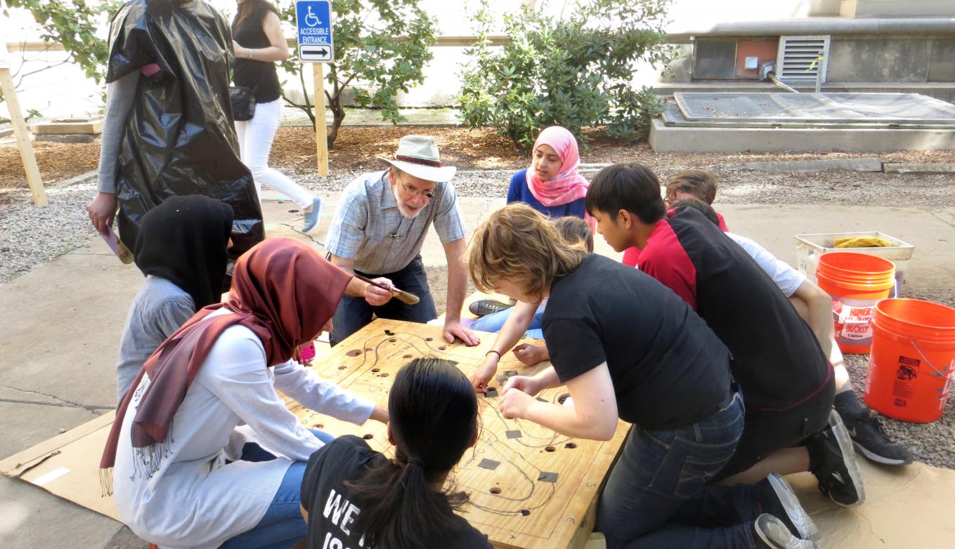 Ed Moriarty outside working on project with students