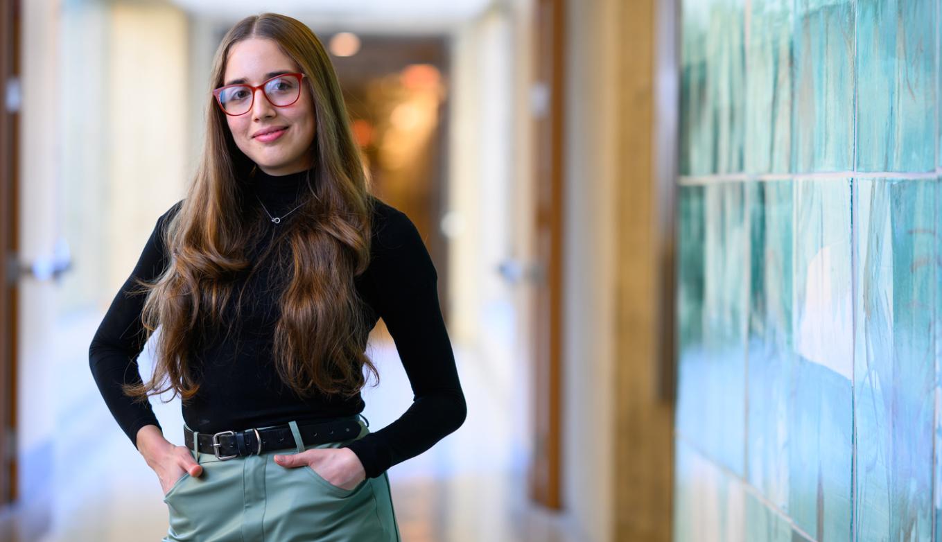 MIT senior Veronica Calzadilla Sosa smiles next to a blue tile wall