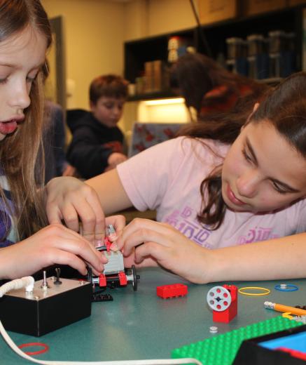 Building a Lego car in the Edgerton Center classroom program