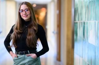 MIT senior Veronica Calzadilla Sosa smiles next to a blue tile wall