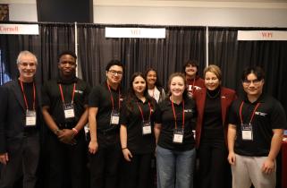 Members of FIRSTxMIT smile with Massachusetts Governor Maura Healey