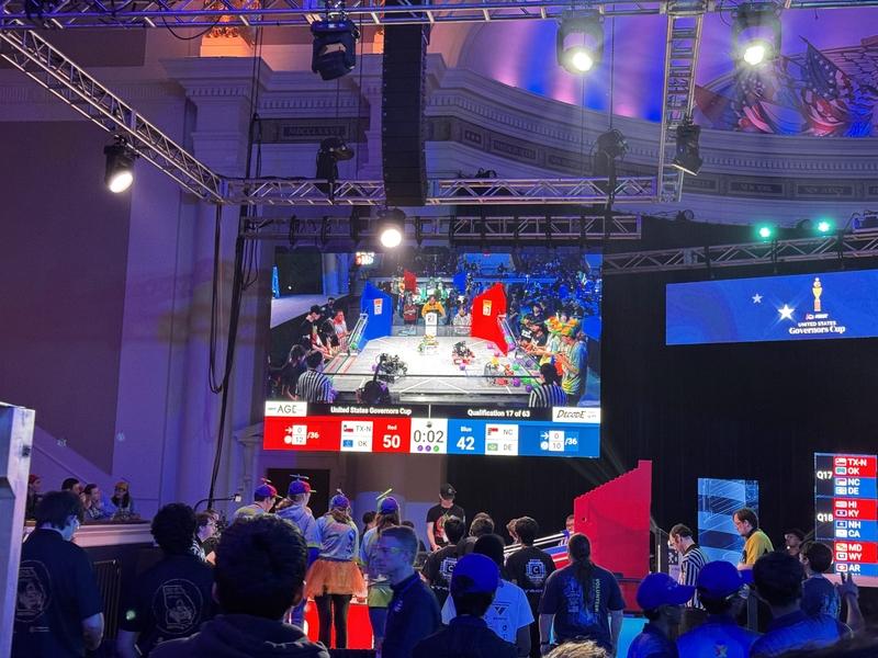 A large screen provides an overhead view of 2 robotics teams competing at the Governor's Cup
