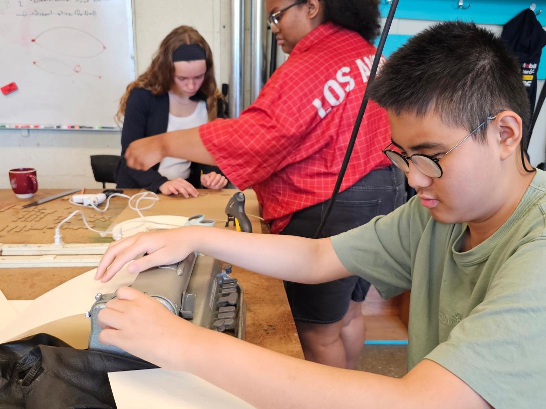 Harry creates labels in braille using a Perkins Brailler