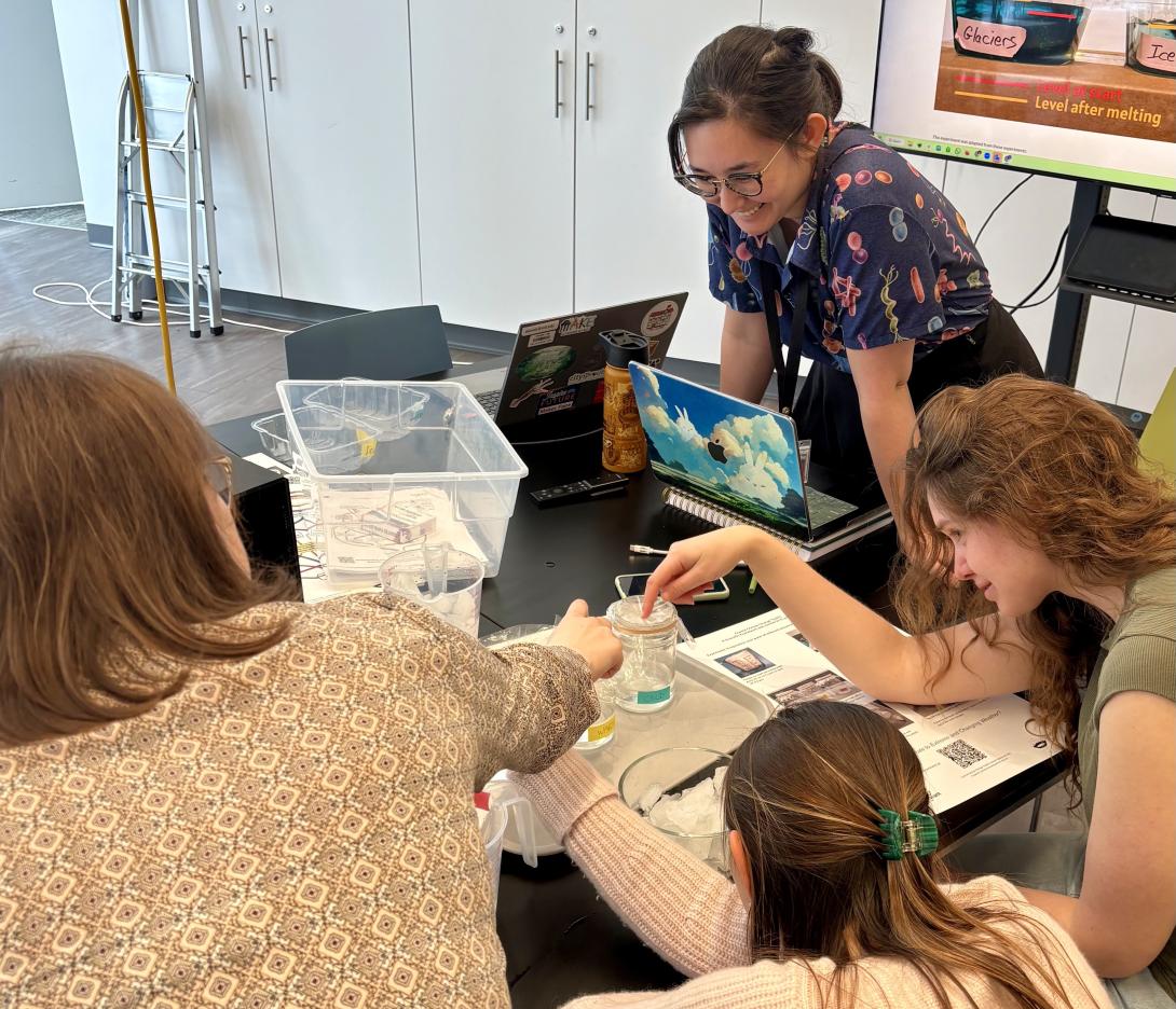 MIT Museum staff gathers around a tabletop experiment