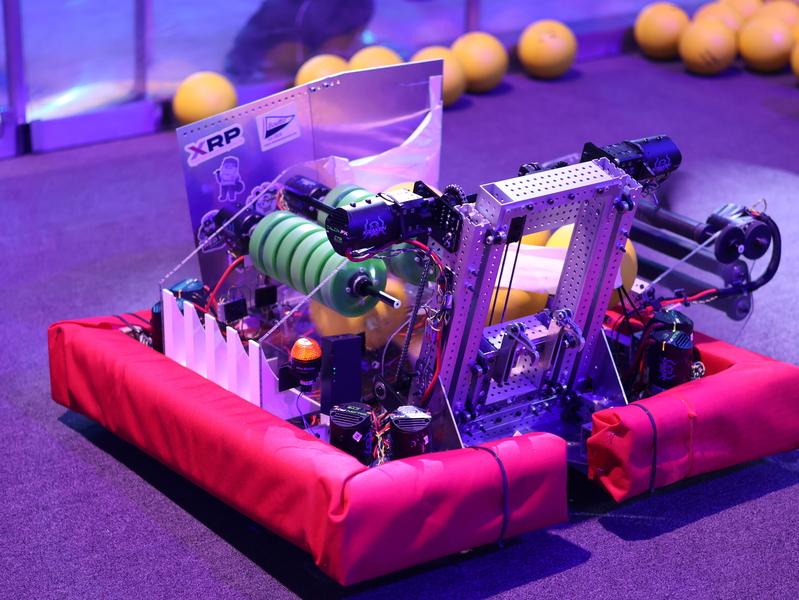 Timbot, a square robot with a padded chassis, with yellow foam balls in the background